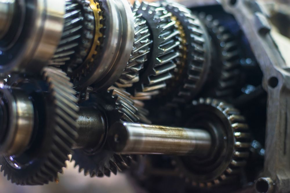 Close-up of automotive transmission gears and components, highlighting intricate mechanical details relevant to expert vehicle repair and maintenance.